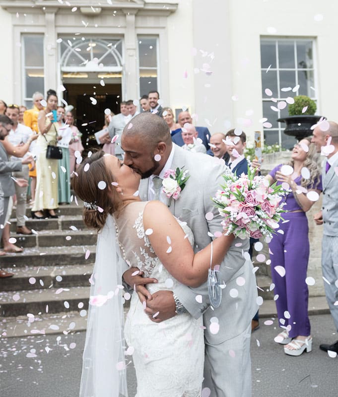 Lovers Passionately Kissing Close To The Heart At A Wedding