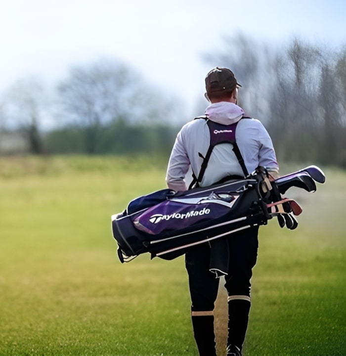 Two golfers walking along the grass